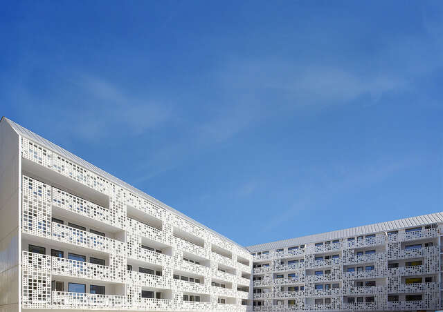 White grid details on the balconies facing the inner courtyard.