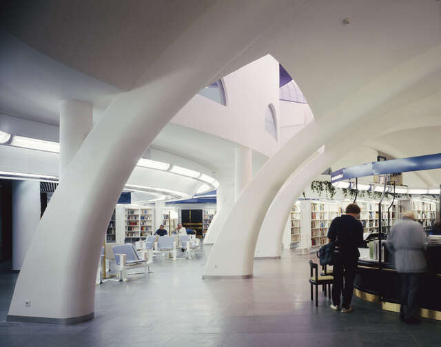 Arched support structures with a library in the back.