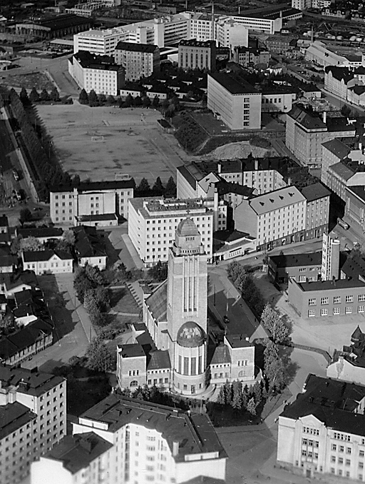 Aerial view of the stone church in the middle of a park and the residential area