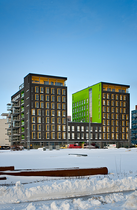 Two eight-storey apartment buildings with bright green inner wall