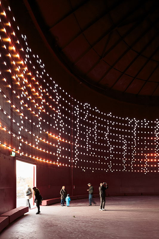 Interior of illuminated silo with visitors