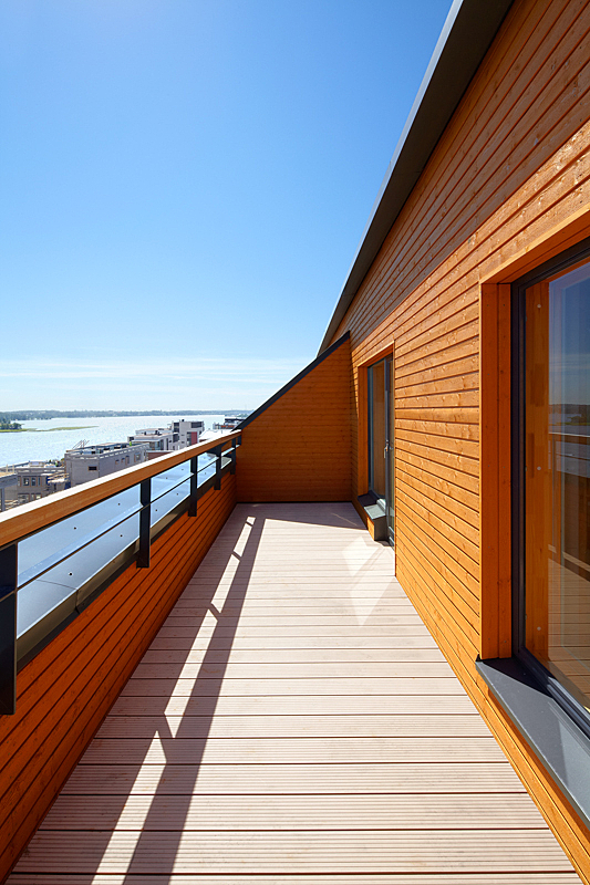 Red and orange coloured terrace walls and railing, and corridor, sea landscape