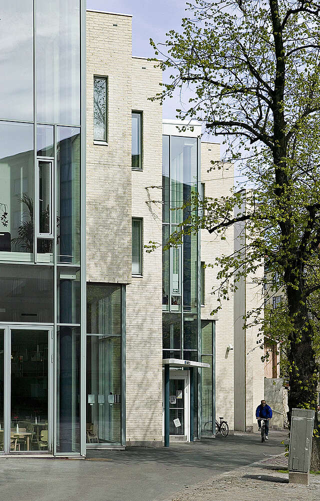 Stepped white brick and glass facade.