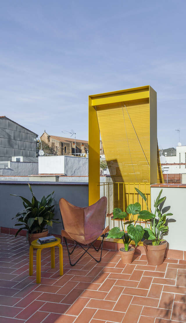 A rooftop of an apartment building with a yellow shade.