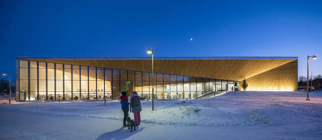 Glass and wood facade of the building on a dark winter afternoon