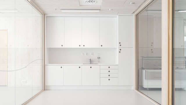 A room with large glass walls and white cabinets