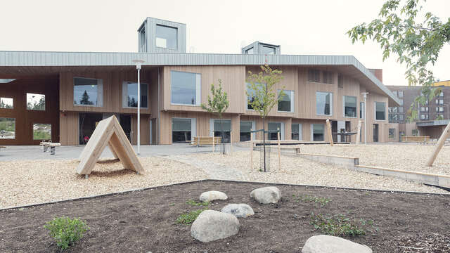 A large wooden building and a yard