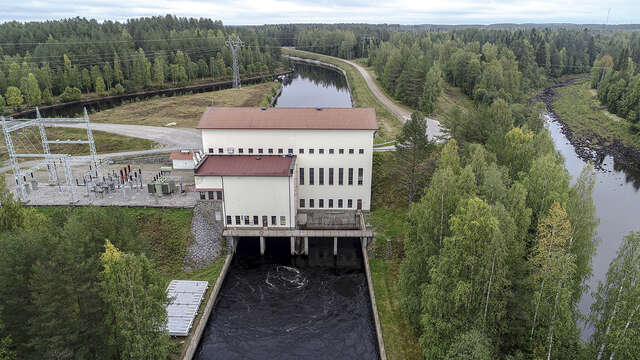 Photo of the white power plant building captured from bird eye view.