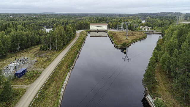 Photo of white building above the river