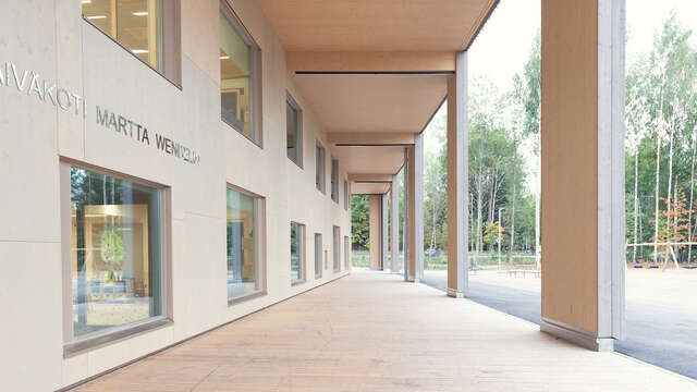 Wooden terrace walkway with a yard to the right.