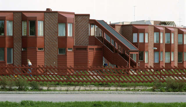 The street facades have angular bay windows to soften the look of the buildings. The precast concrete panels are facing brick-tiles and horizontal boards.