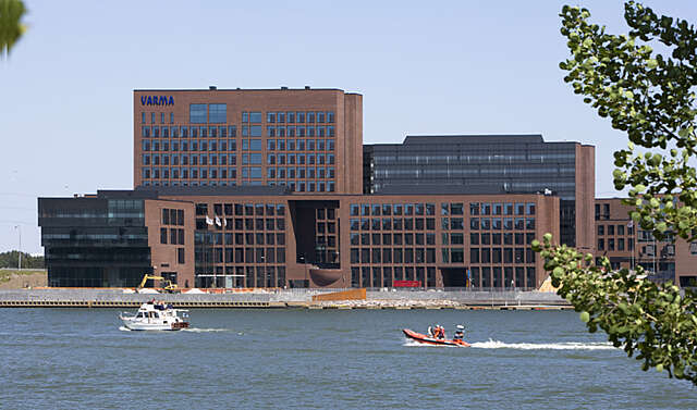 Large red-brick office building on the coast.