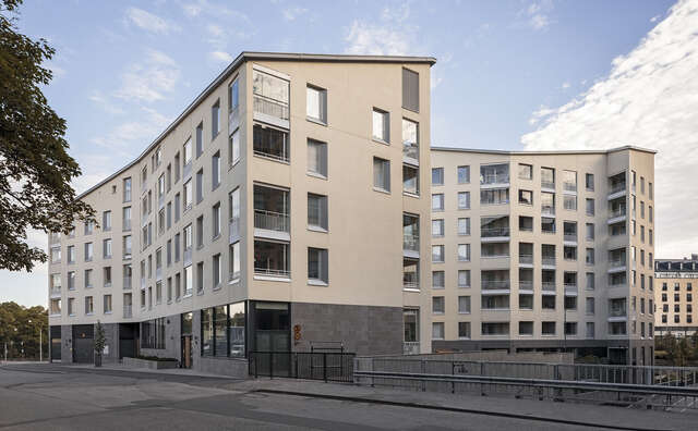 Beige plastered modern apartment building .