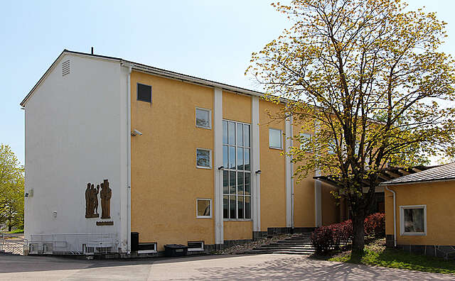 Yellow three level school building.