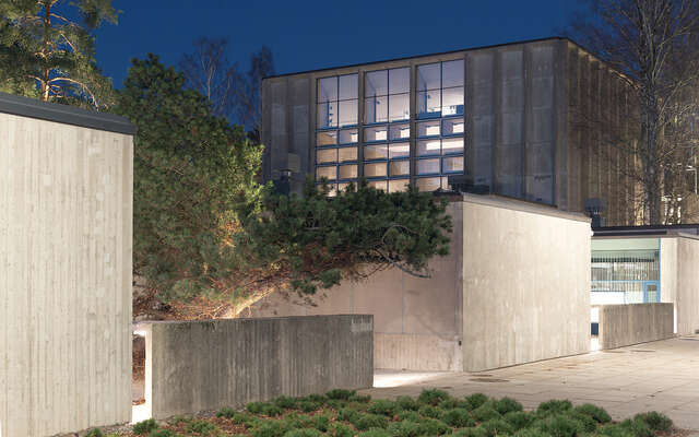 A large, well-lit stone structure during nighttime.