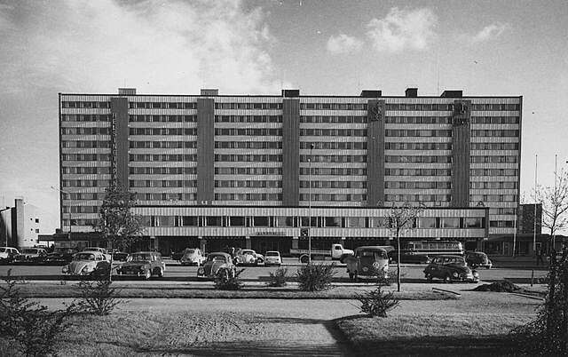 High-rise apartment block of eleven floors and annexe of three floors for commercial premises.