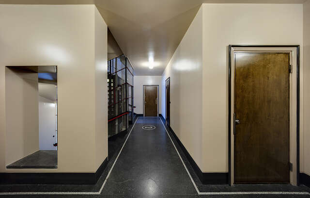 Hallway with stone wood and glass elements.