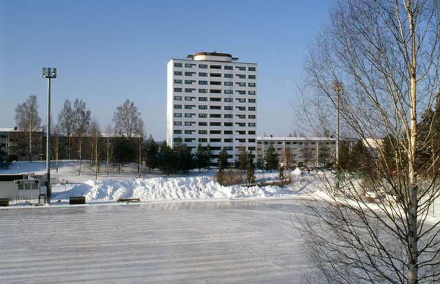 white 13 story residential building in snowy landscape