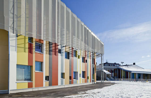Facade of the school building with many different colored panels.