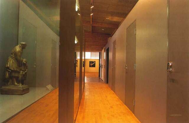 Corridor with display case on the left.