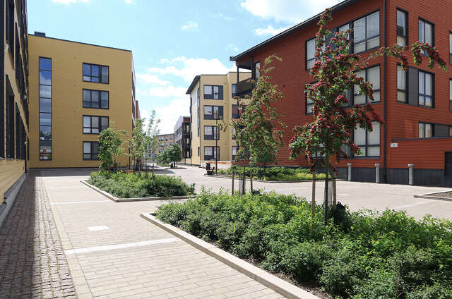 Yellow and red 4-storey high blocks of flats.