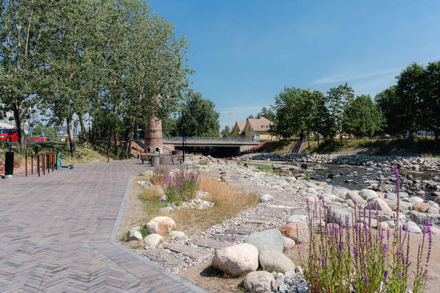 A paved walkway next to a river