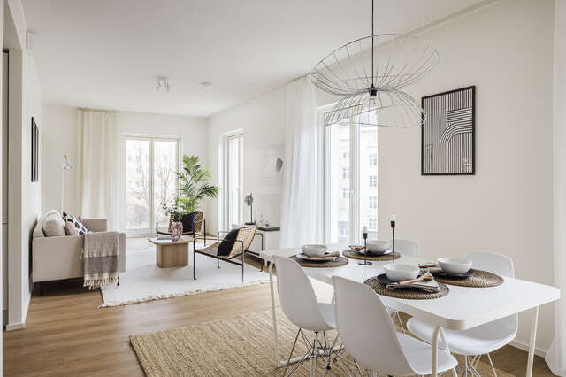 A living room of an apartment building with white walls.