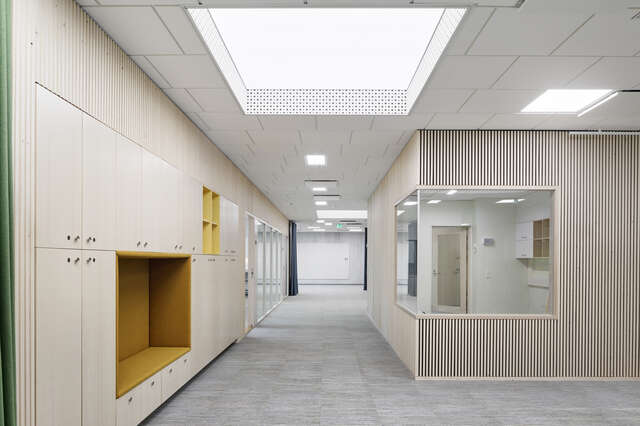 A indoor area with lockers and a booth, all made of wood.