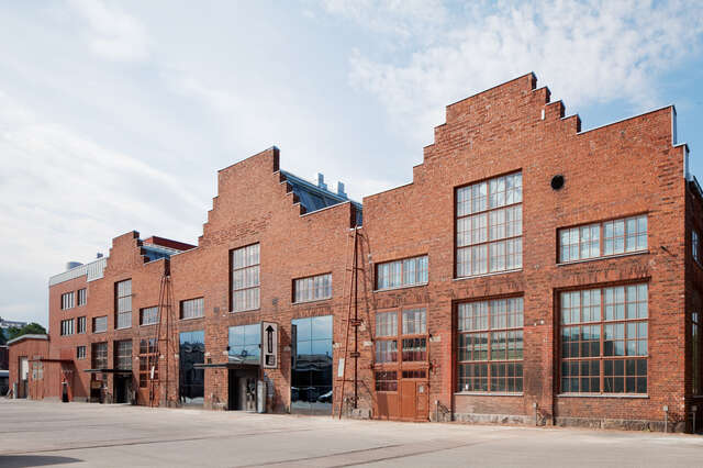 Red brick façade with three gables and large windows