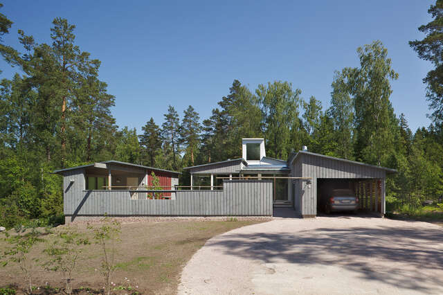 Wooden fence in front of the villa and a garage next to the entrance way
