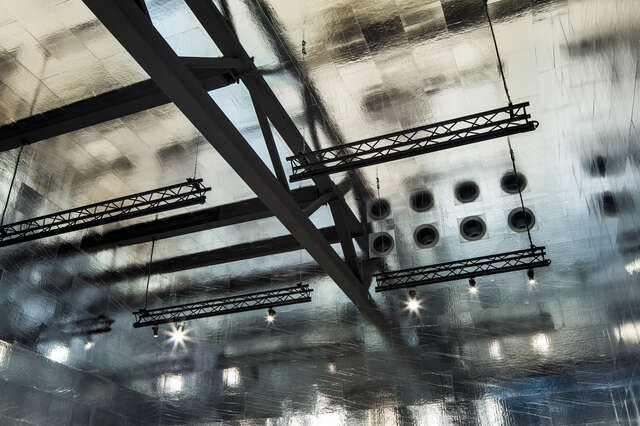 The metallic ceiling reflects light.