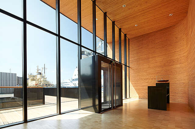 Entrance window wall and main door with robust black metal frames