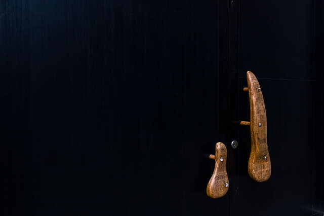 Detail of wooden handles of a black door