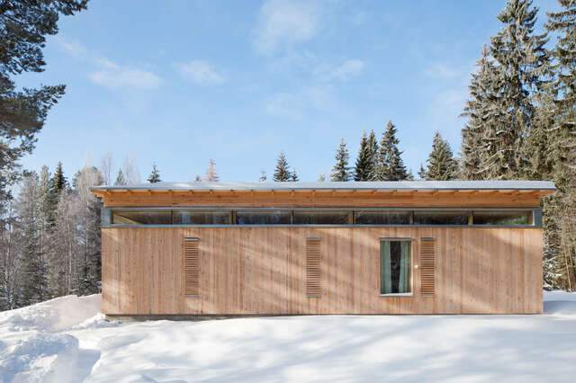 Timber façade of the villa in snowy landscape