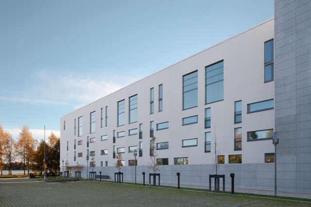 White residential building with multiple square windows