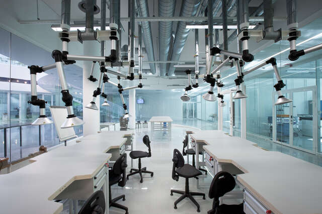 Transparent work space with machines, tables and chairs