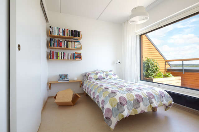 Bedroom with bookshelves and window
