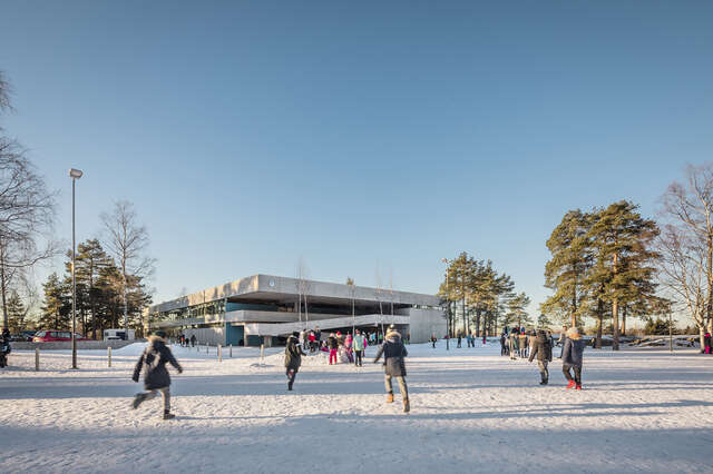 Children playing in a snowy school yard.