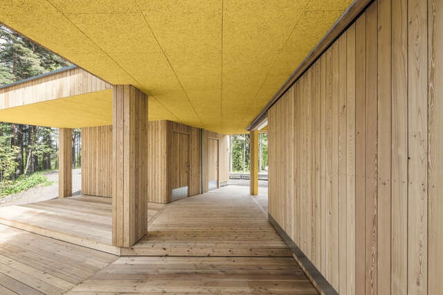 Wooden terrace, wooden columns and wall, yellow ceiling