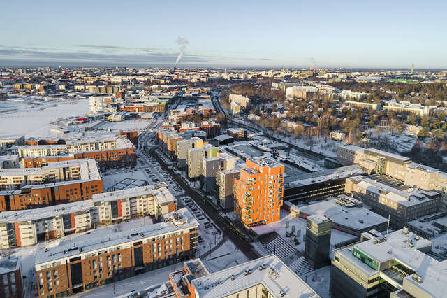 Snowy city district with modern apartment buildings.