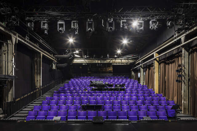 Rows of purple seats inside a theatre.