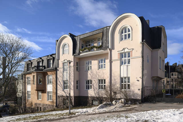 Light pink and brown plastered villas next to each other.