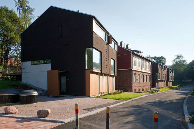 Three houses made from multiple materials and with different styles.