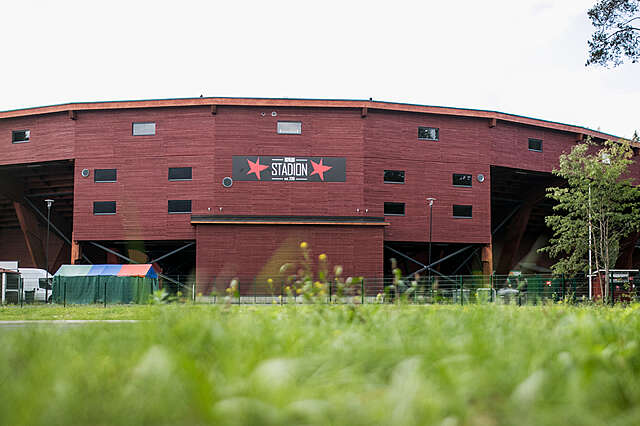 View from the backside, dark red wood covered facade