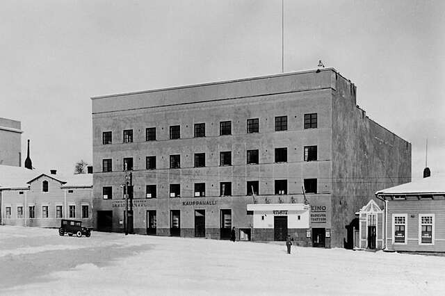 Bare concrete facade of the building in a black and white picture.