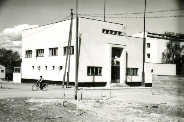 A black and white photo of the white police station building.