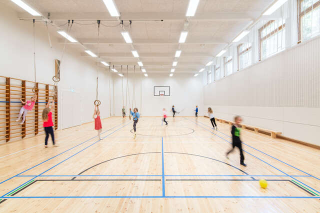 Indoor gym with wooden court.