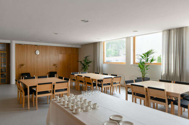 Interior cafeteria with tables and seats.