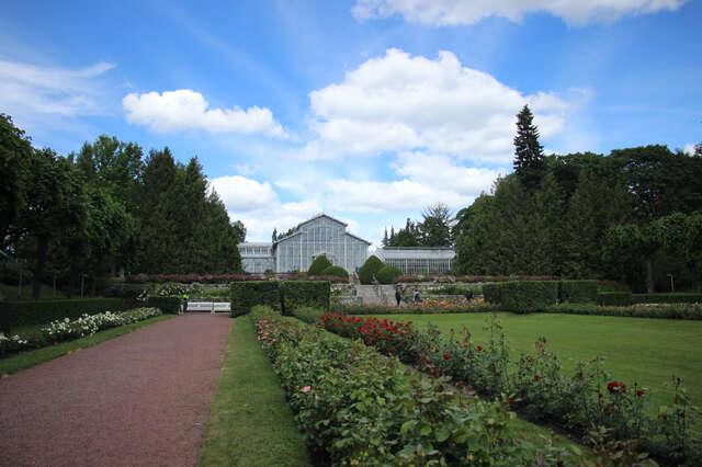 Flowerbeds and lawn in front of the large winter garden.