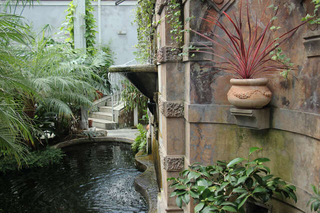 Fountain with water dripping into a artificial pond.